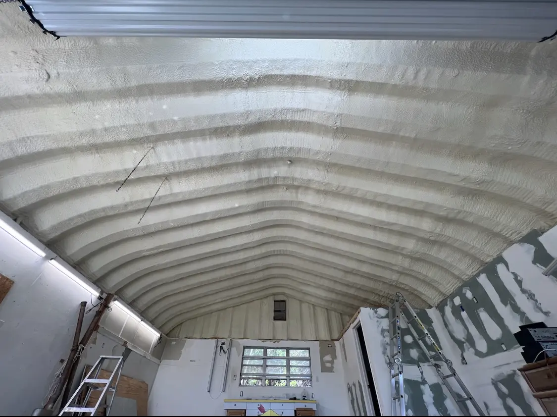Spray polyurethane foam applied to the underside of a metal roof deck in Clawson